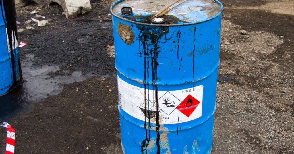 A blue canister with solvent drippings on the side. The chemical is contaminated and requires solvent recycling.