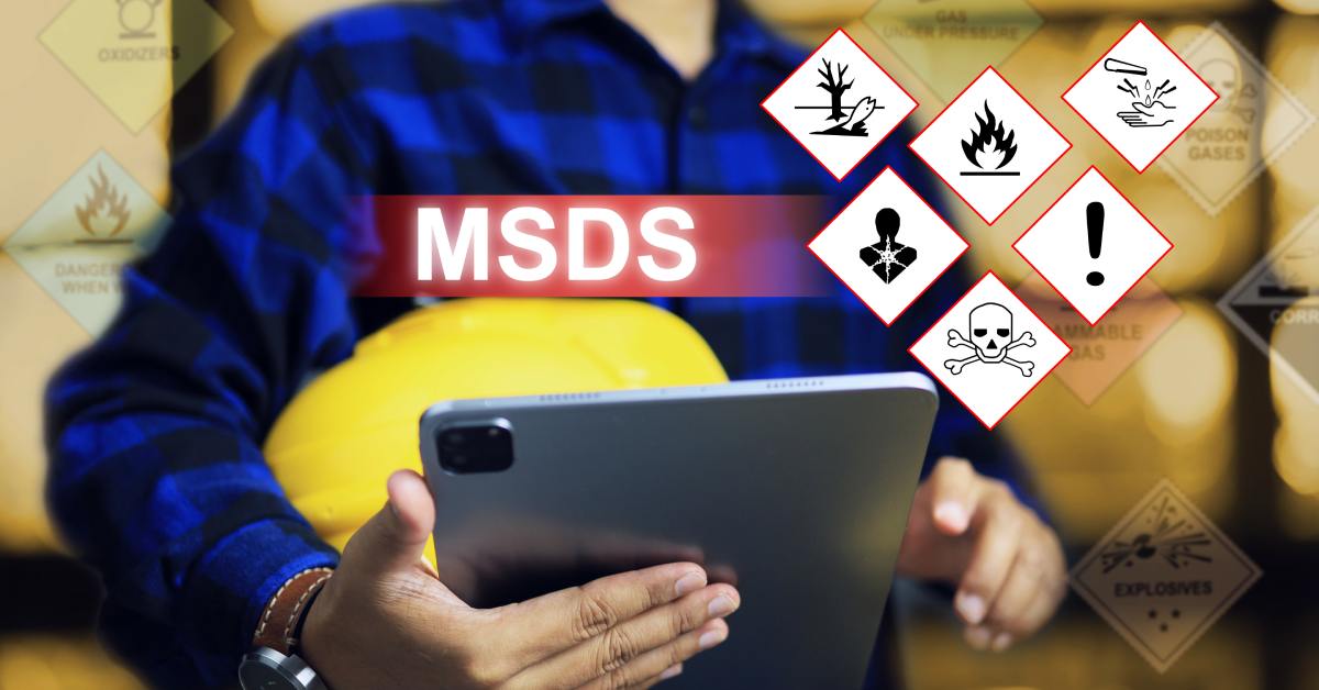 A person holding yellow hard hat and tablet with holographic hazard icons floating above it indicating fire, poison, health, and environmental risks.