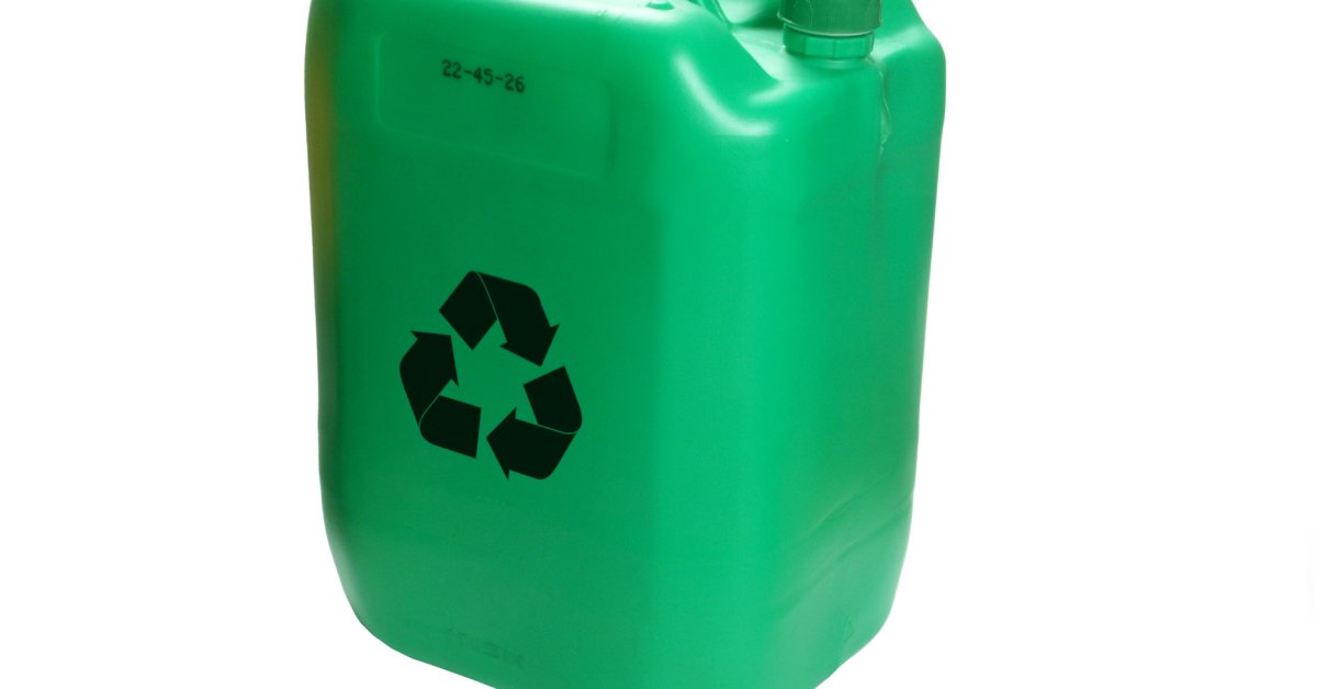 A large, green jug sits on a plain, white background. The green jug contains the recycling symbol in black on the side.